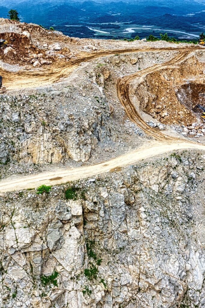 Aerial view of a quarry with heavy machinery in Purwakarta, West Java, Indonesia.