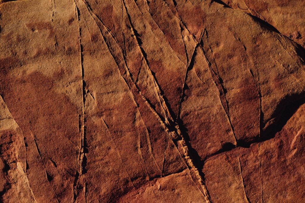 Detailed close-up of a cracked desert rock showcasing arid textures.