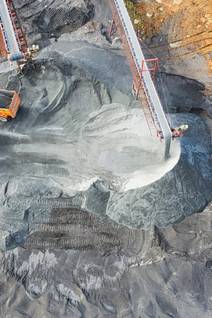 A top-down view showcasing mining operations with excavators and conveyor belts.