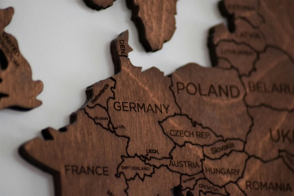 Detailed wooden map of Europe highlighting countries like Germany and Poland.