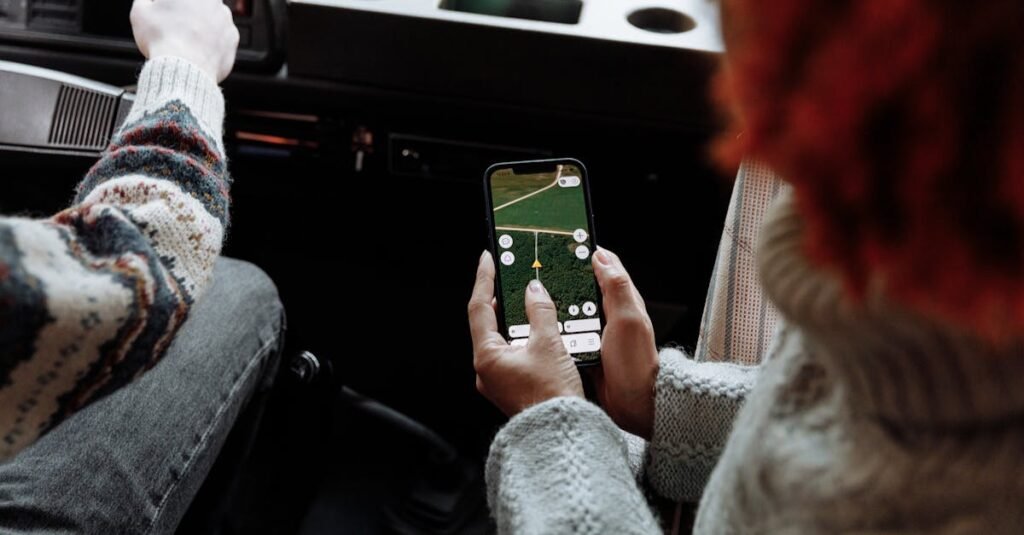 Two people using a navigation app on a smartphone during a road trip